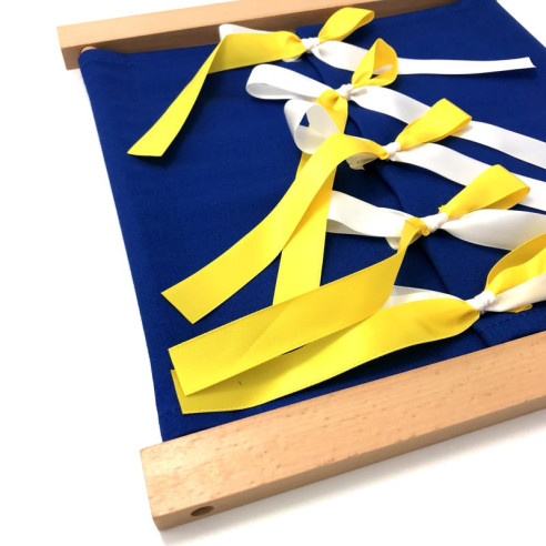 Cadre d'habillage Montessori bleu foncé avec des rubans jaunes d'un coté et blanc de l'autre vu de trois quarts.