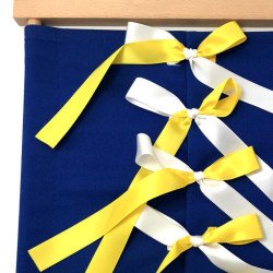 Cadre d'habillage rubans Montessori bleu foncé avec des rubans jaunes d'un coté et blanc de l'autre vu de détail.